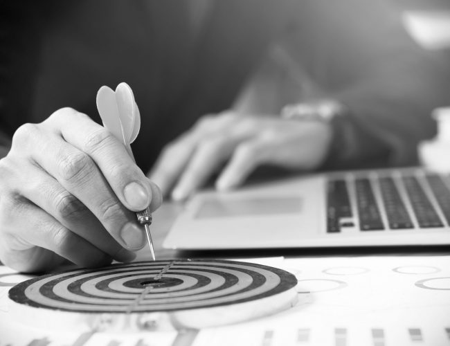 Businessman holding red dart push on target. Business strategy planning success target goals. Business development concept