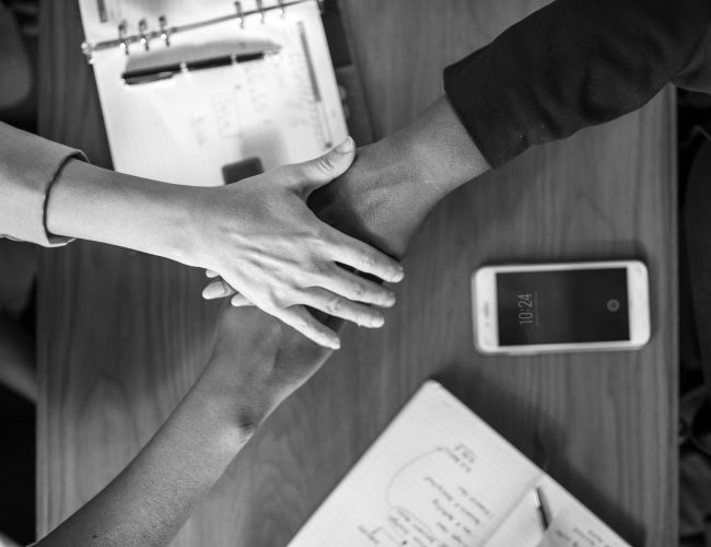 Diverse business team stacking hands